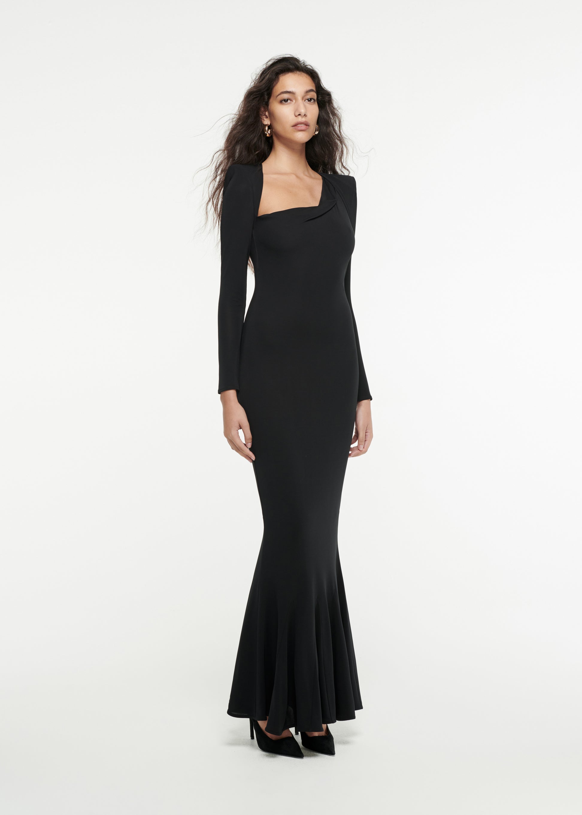 Woman wearing the Long Sleeve Asymmetric Gown in Black 