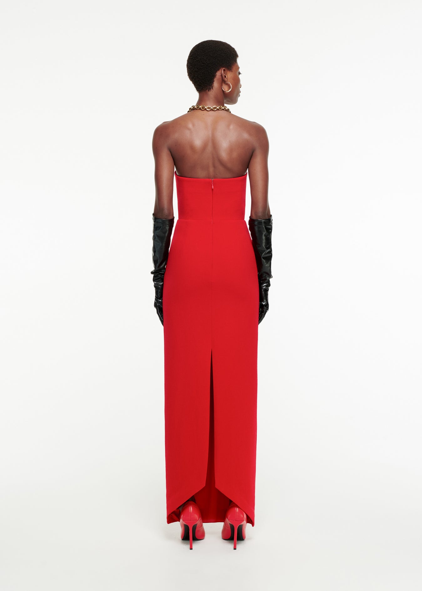 The back of a woman wearing the Strapless Origami Gown in Red 
