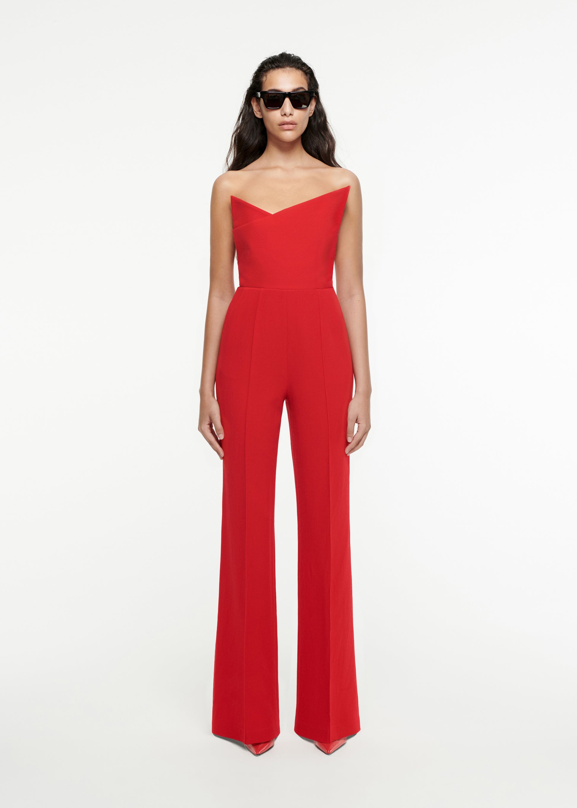Woman wearing the Asymmetric Wool Crepe Jumpsuit in Red