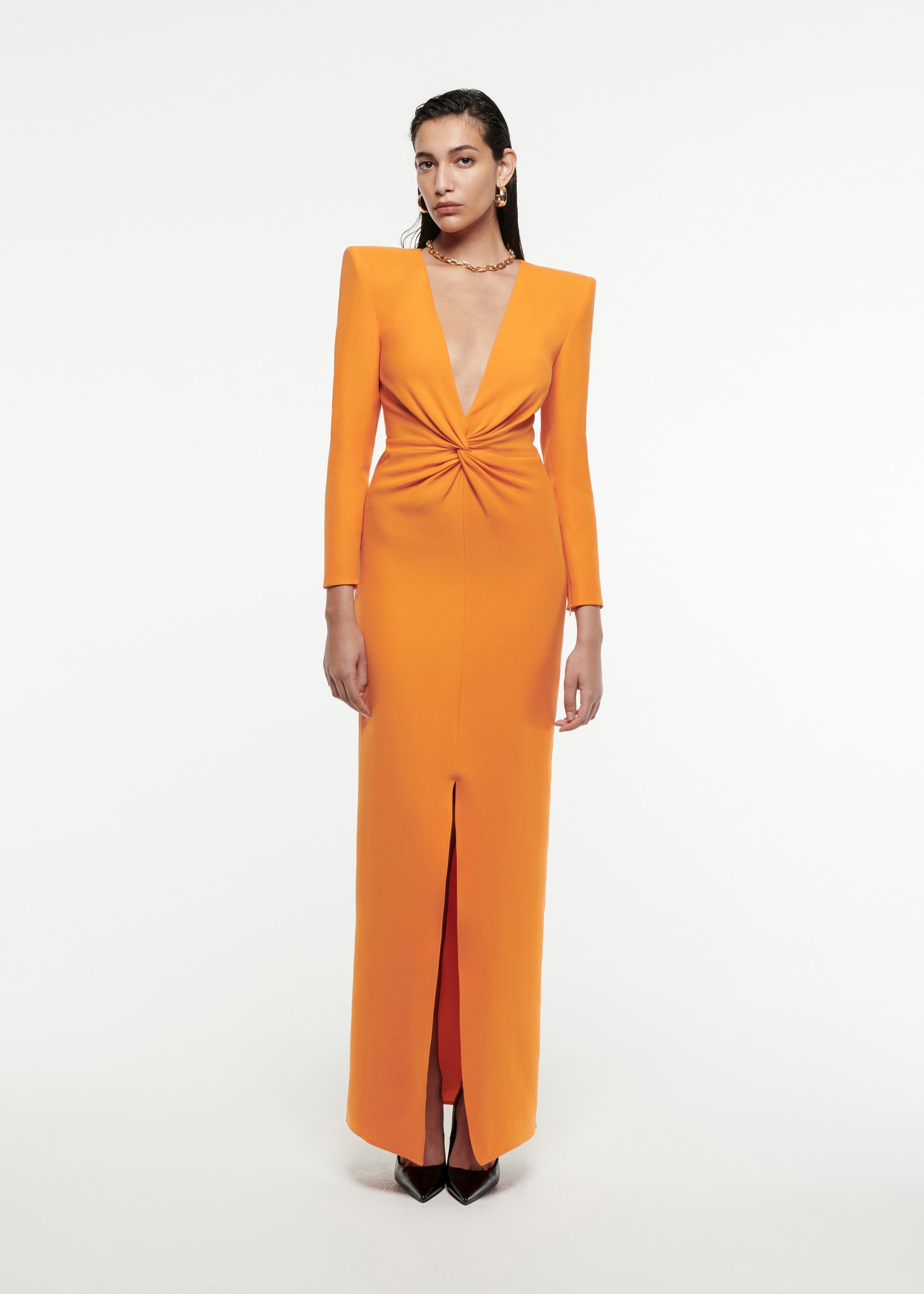 Woman wearing the Twist-Front Silk Wool Gown in Orange