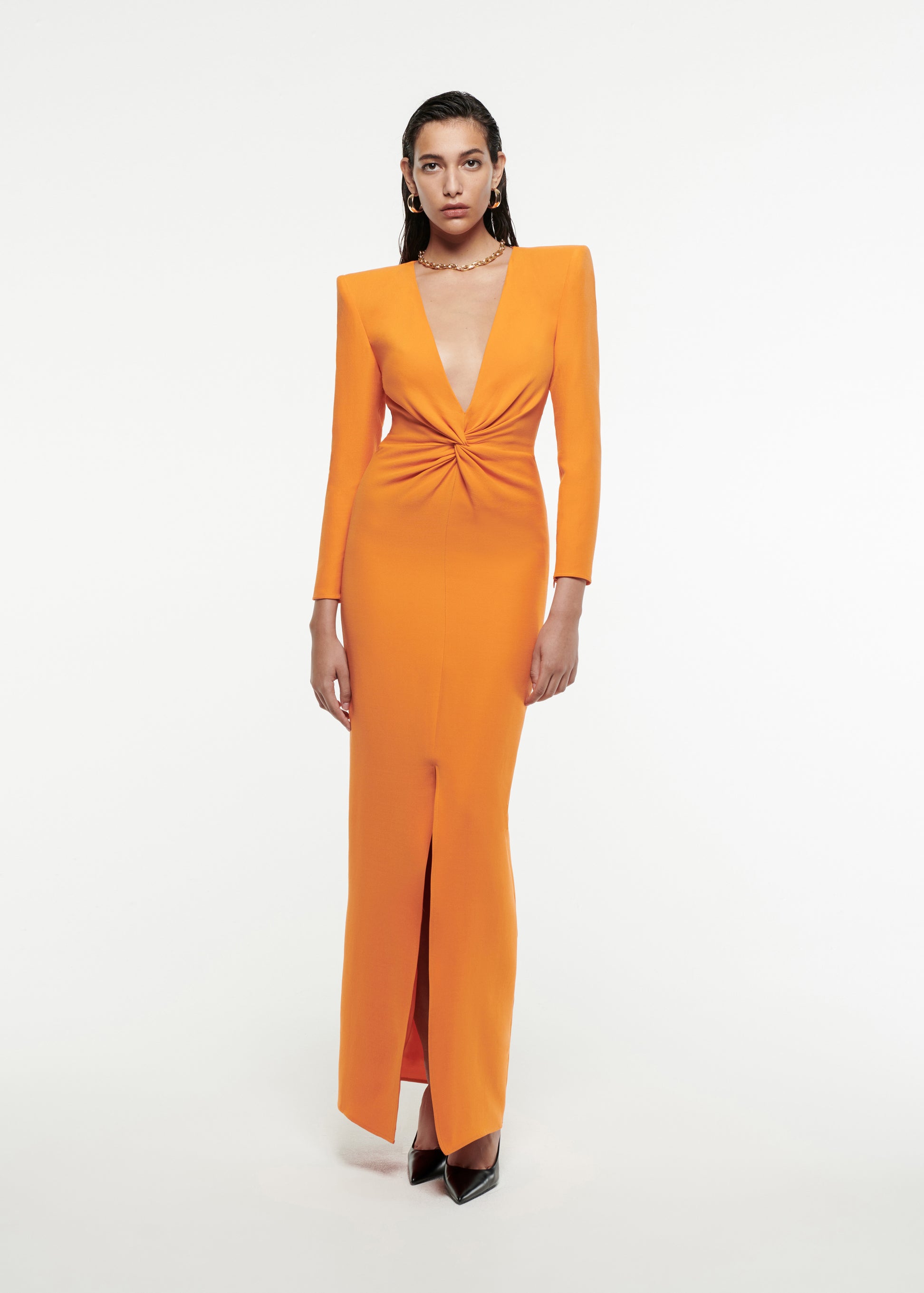 Woman wearing the Twist-Front Silk Wool Gown in Orange