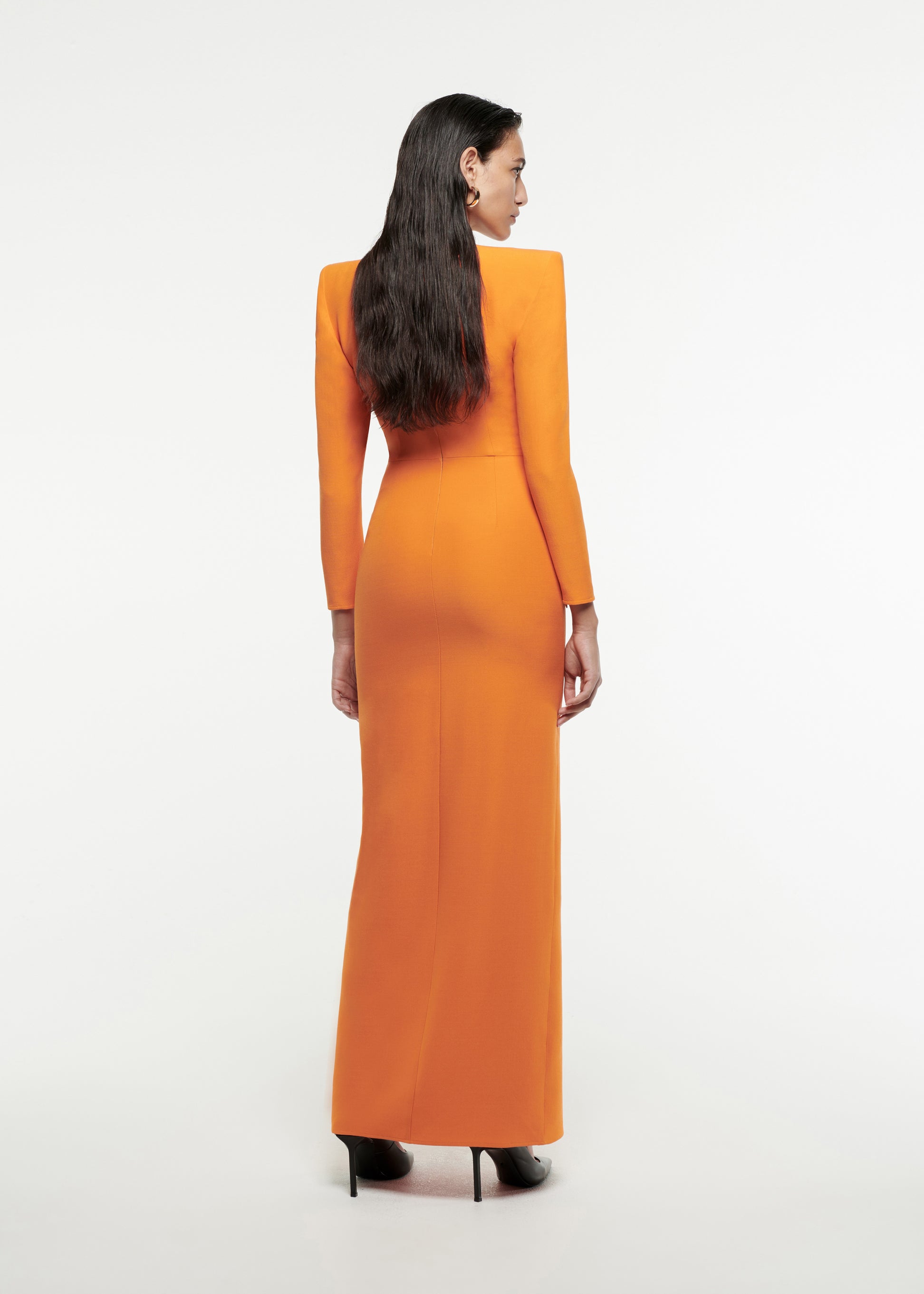 The back of a woman wearing the Twist-Front Silk Wool Gown in Orange