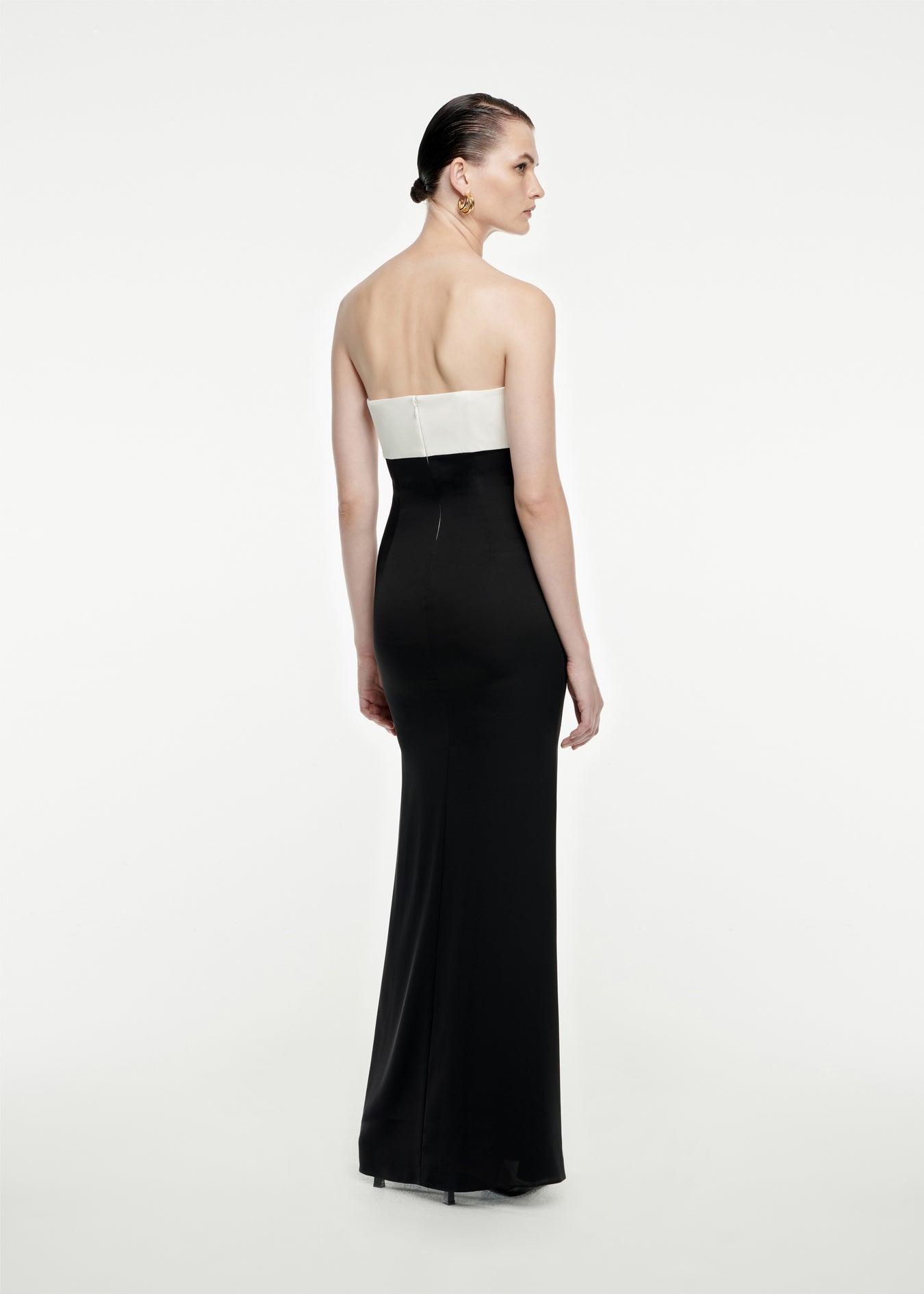 The back of a woman wearing the Strapless Stretch Silk Crepe Maxi Dress in Black