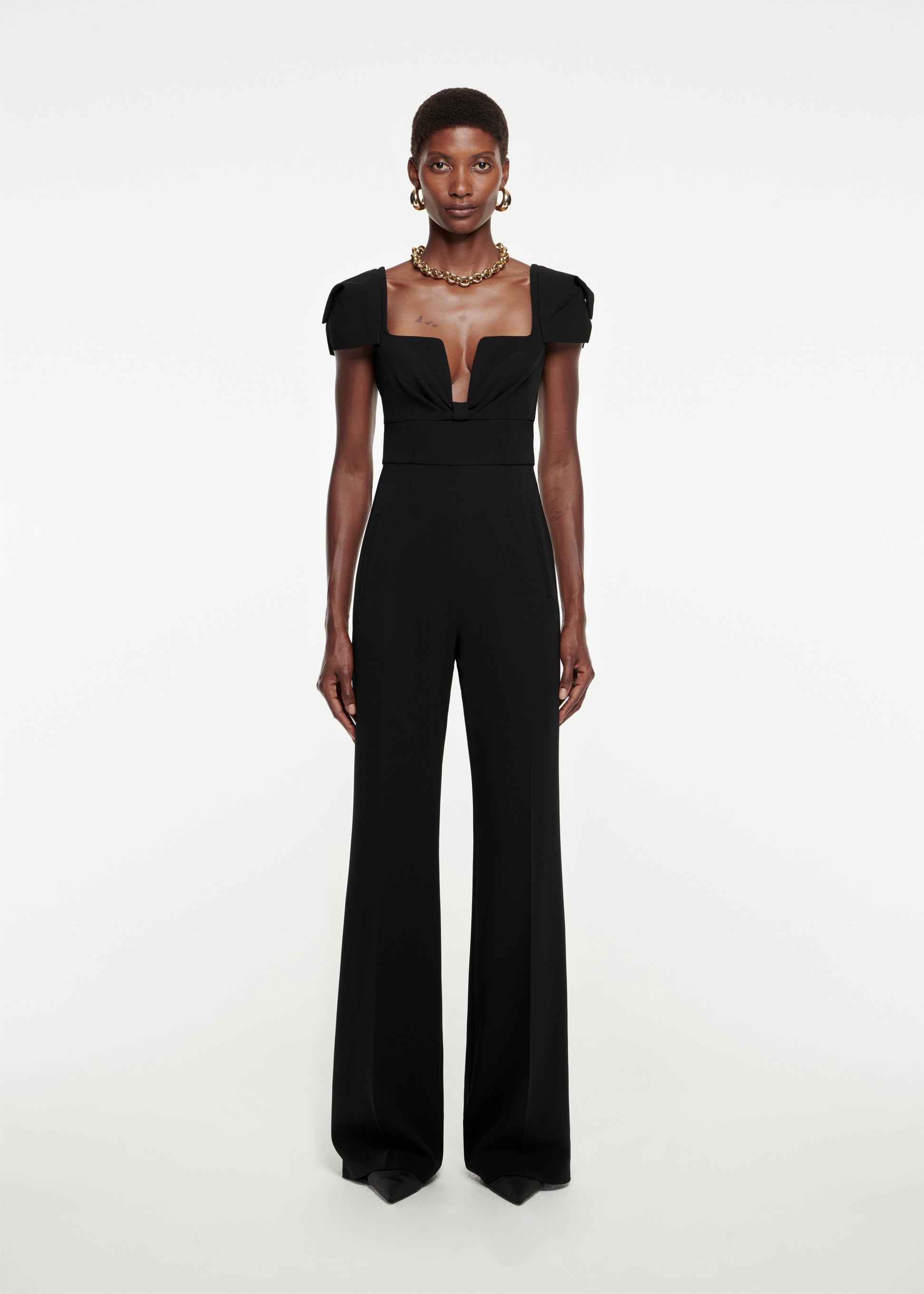 Woman wearing the Cap Sleeve Stretch-Cady Jumpsuit in Black