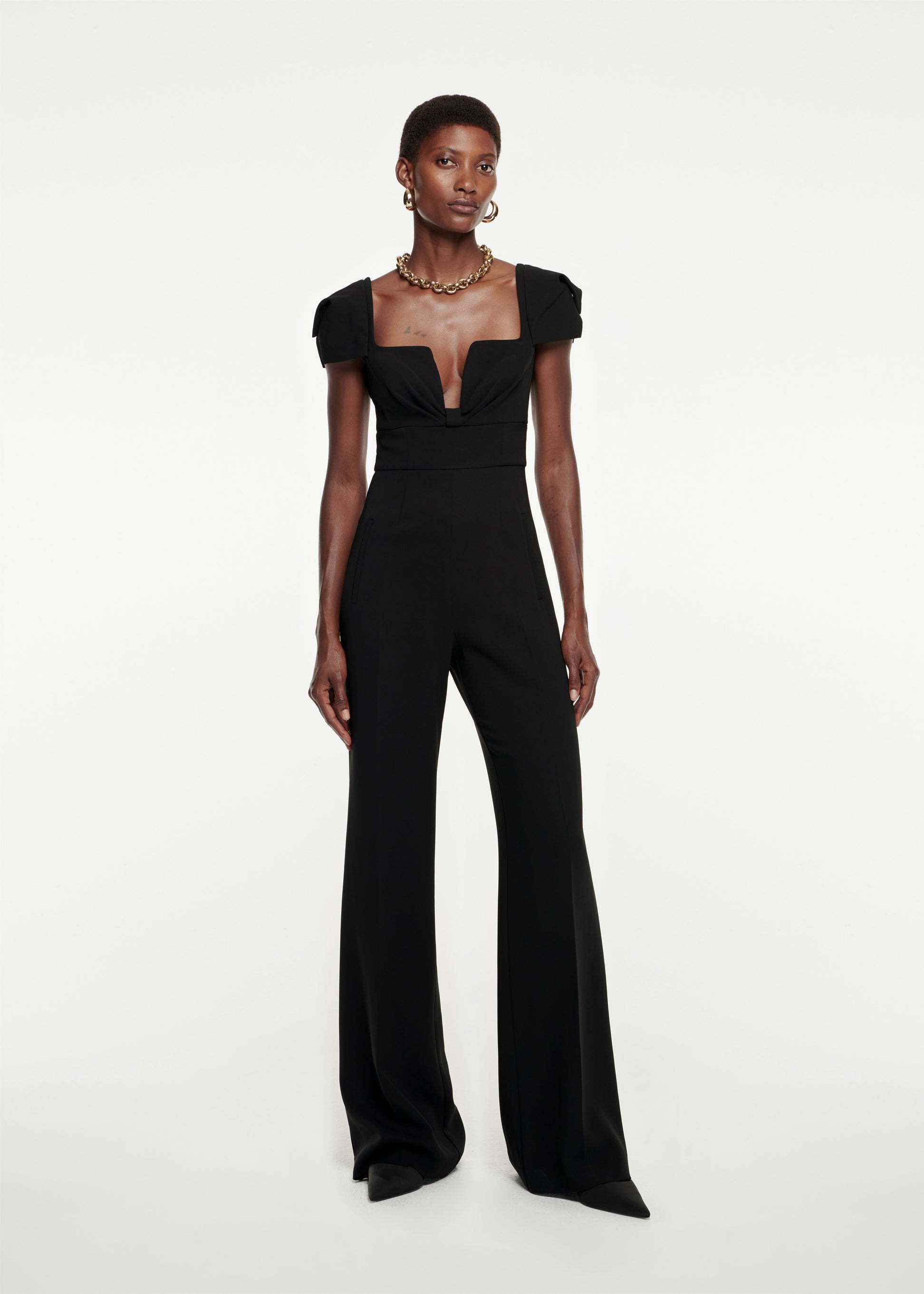 Woman wearing the Cap Sleeve Stretch-Cady Jumpsuit in Black