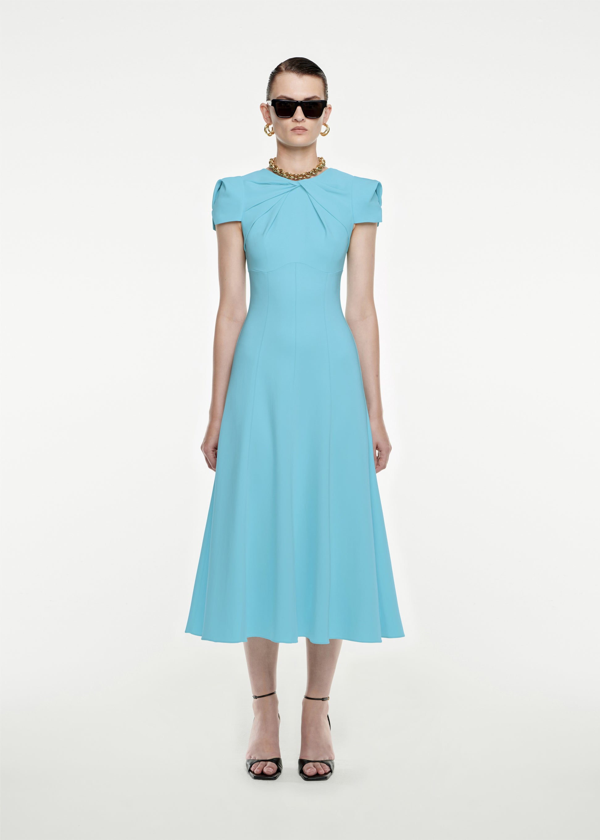 Woman wearing the Cap Sleeve Stretch-Cady Midi Dress in Blue