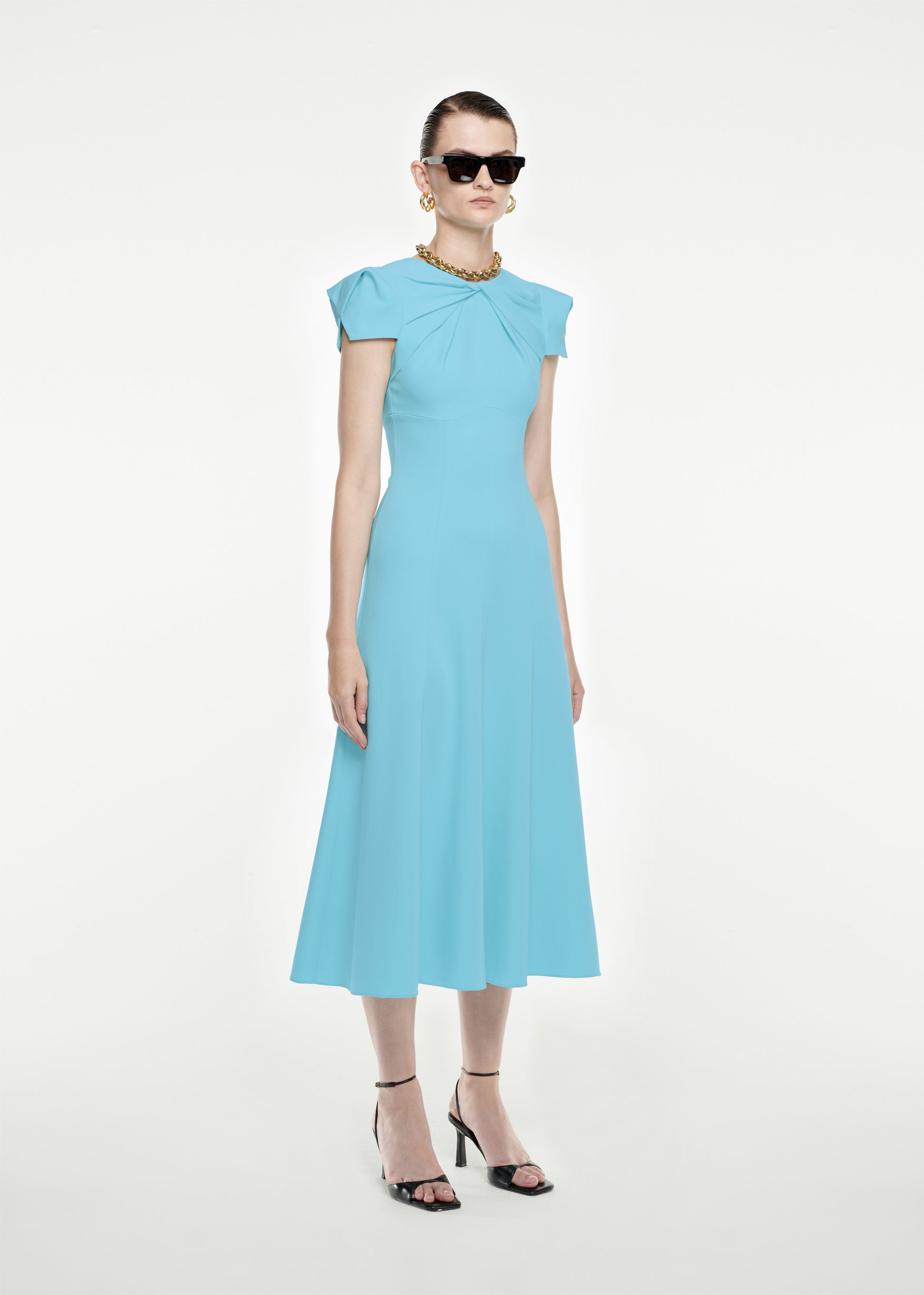 Woman wearing the Cap Sleeve Stretch-Cady Midi Dress in Blue