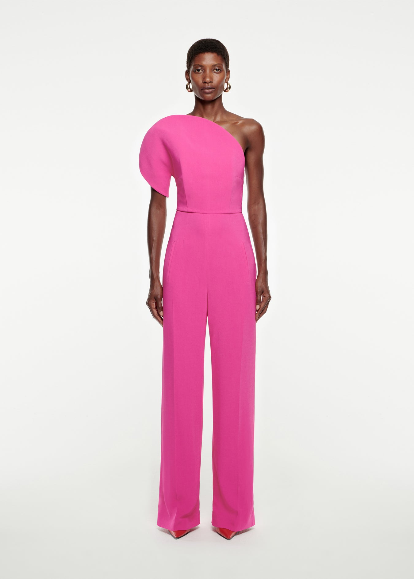 Woman wearing the Asymmetric Stretch-Cady Jumpsuit in Pink