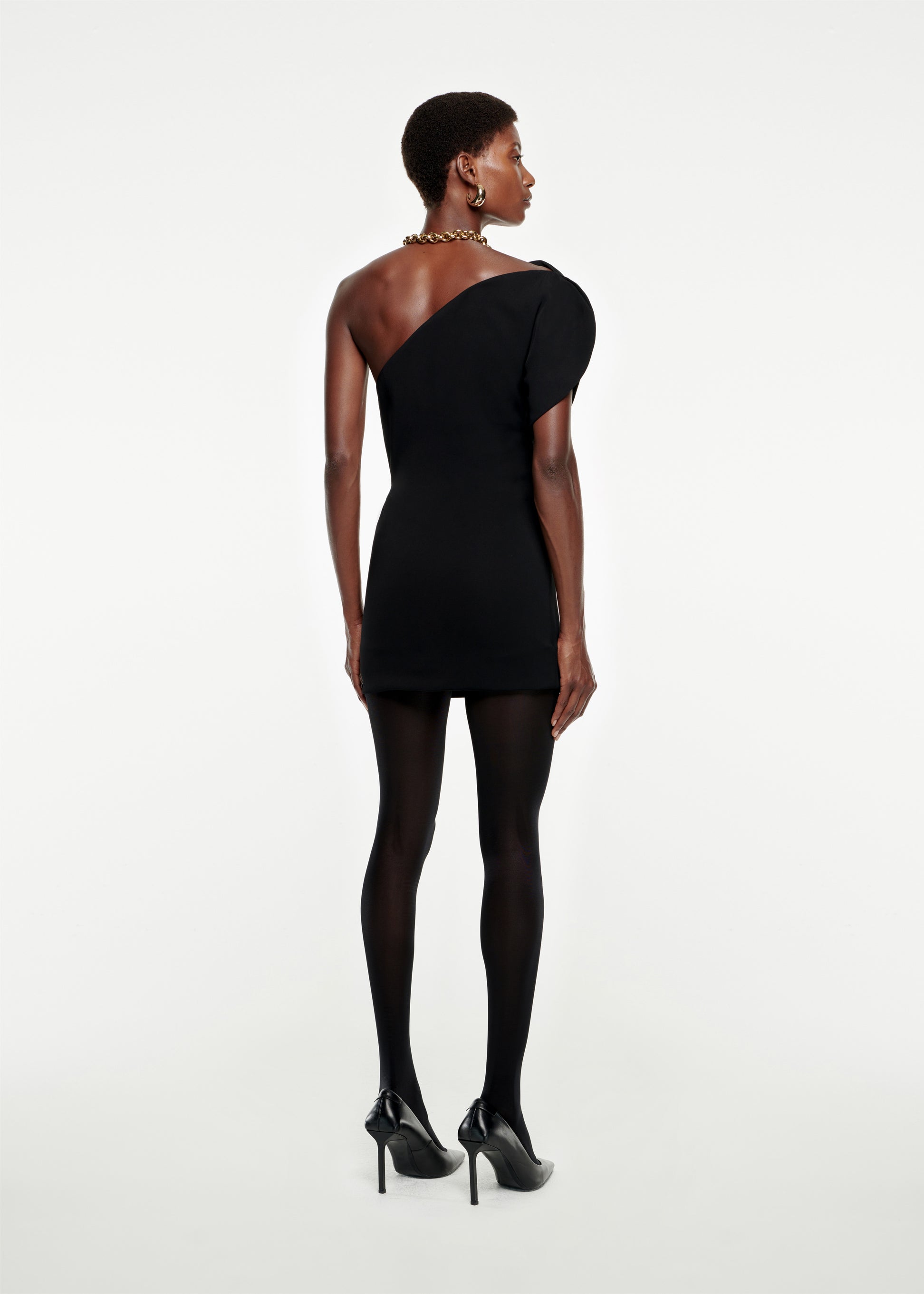 The back of a woman wearing the Asymmetric Stretch-Cady Mini Dress in Black