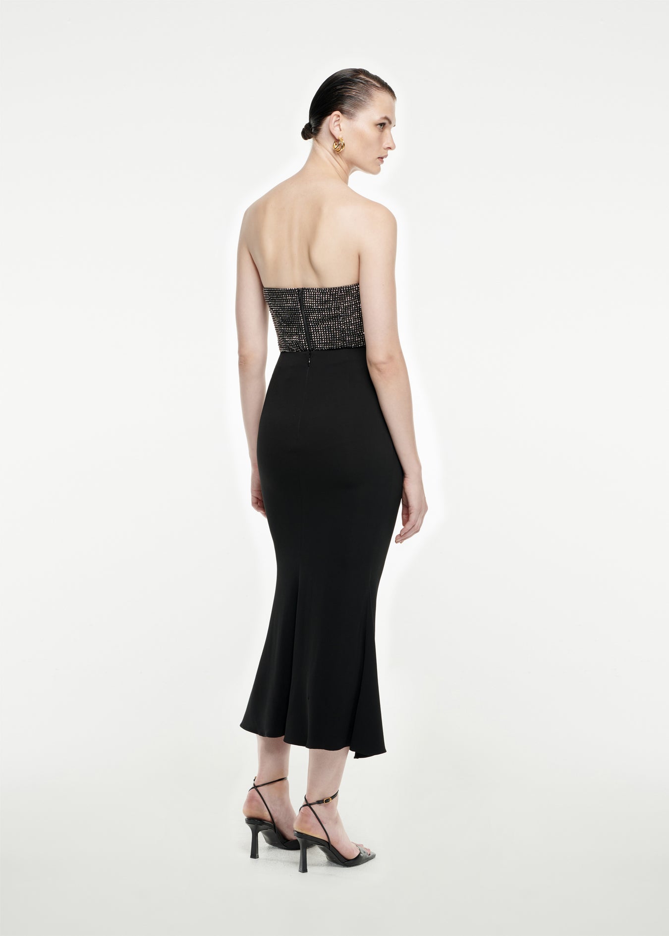 The back of a woman wearing the Strapless Diamante Top in Black