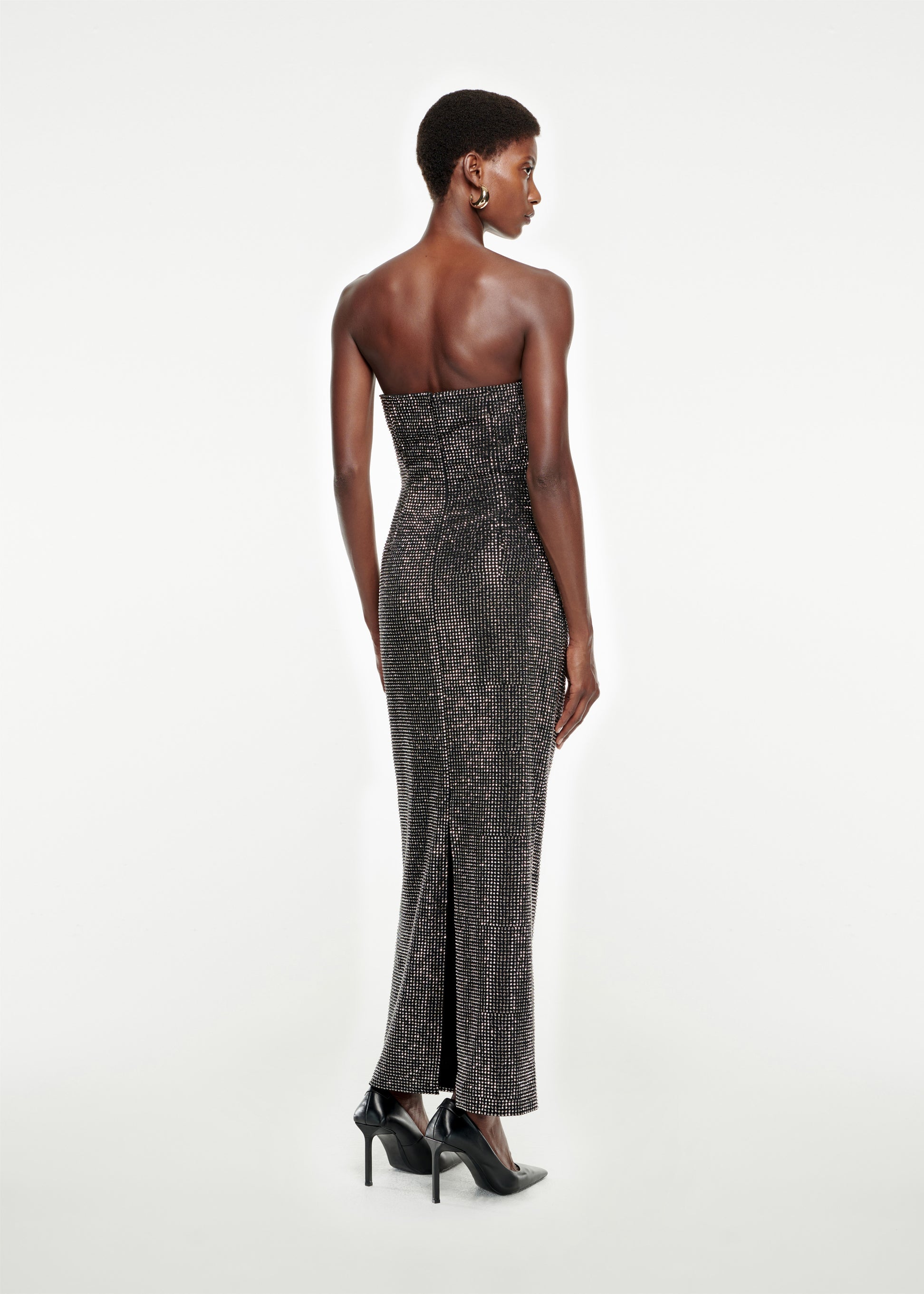 The back of a woman wearing the Strapless Diamante Maxi Dress in Black