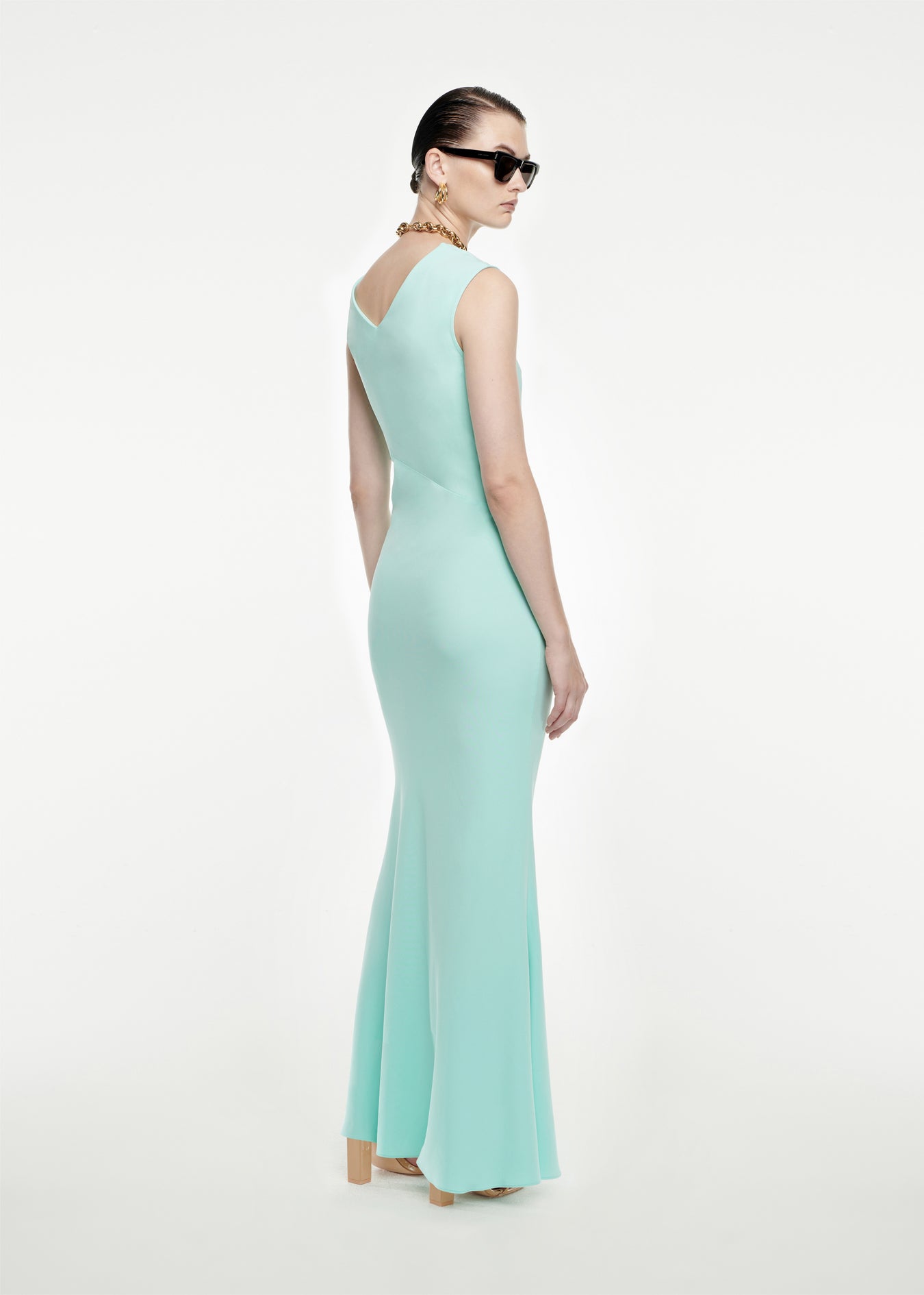 The back of a woman wearing the Stretch-Cady Maxi Dress in Blue