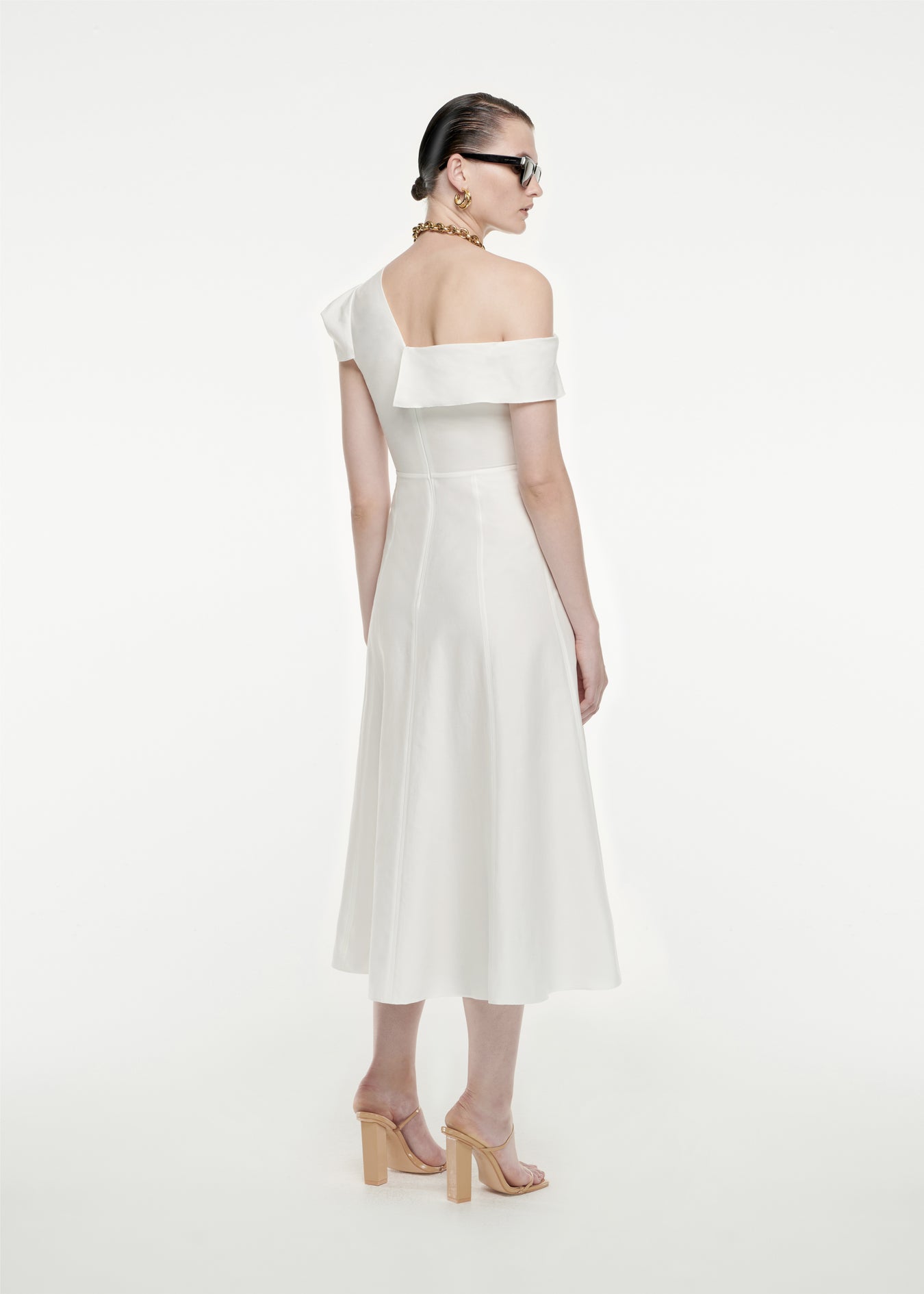 The back of a woman wearing the Asymmetric Cotton Poplin Midi Dress in White