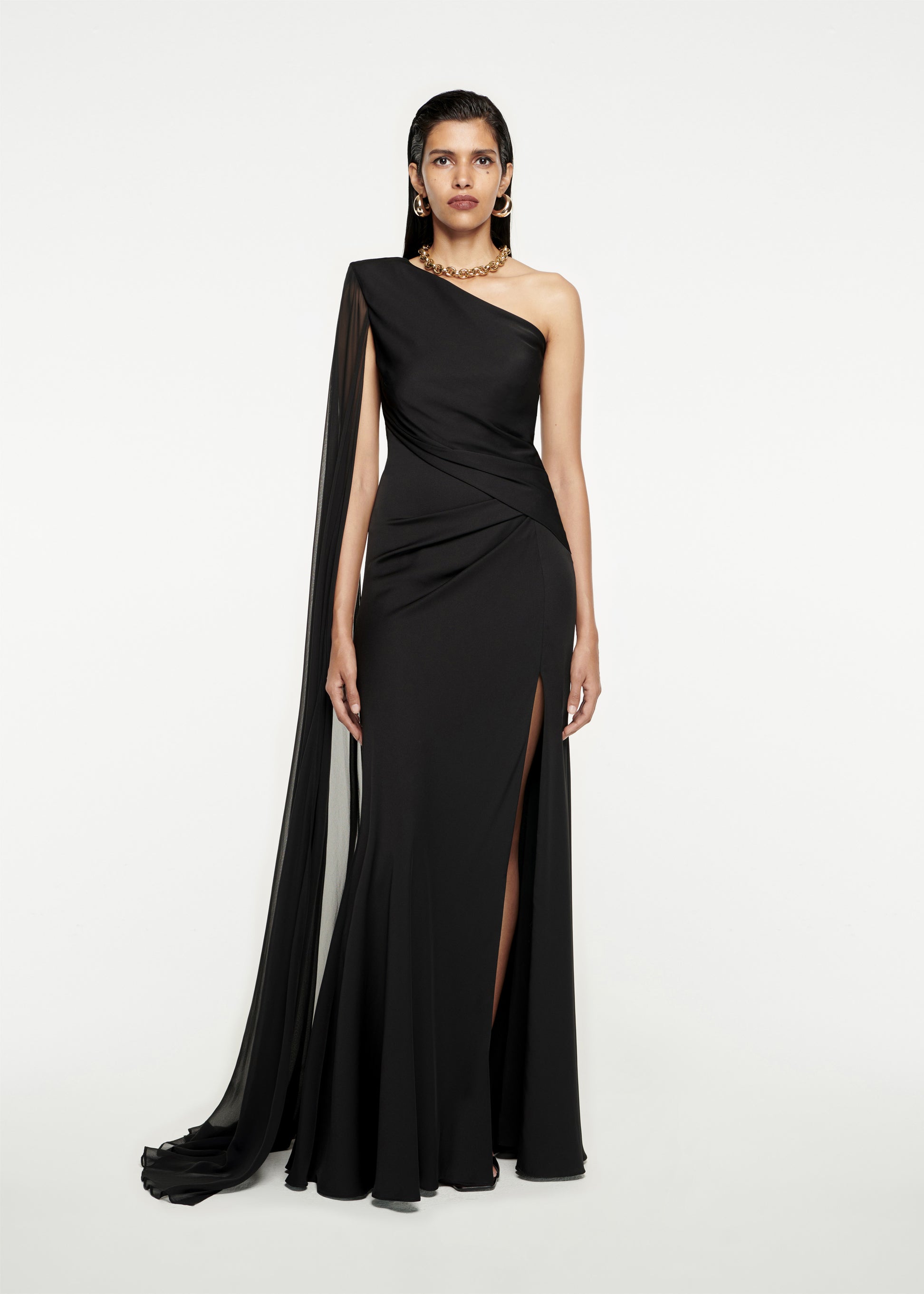 Woman wearing the Asymmetric Stretch Silk Crepe Gown in Black