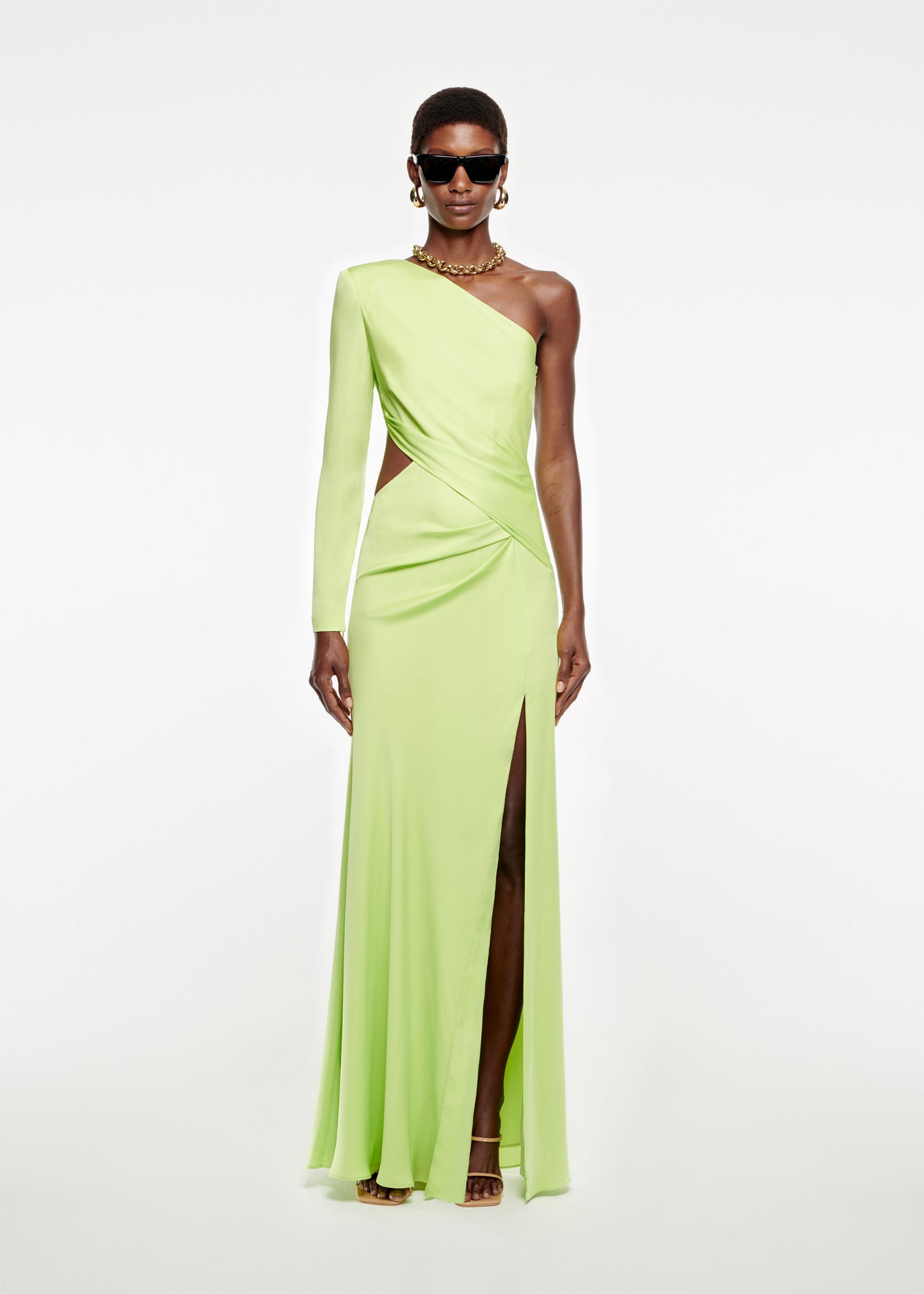 Woman wearing the Asymmetric Stretch Silk Crepe Gown in Green