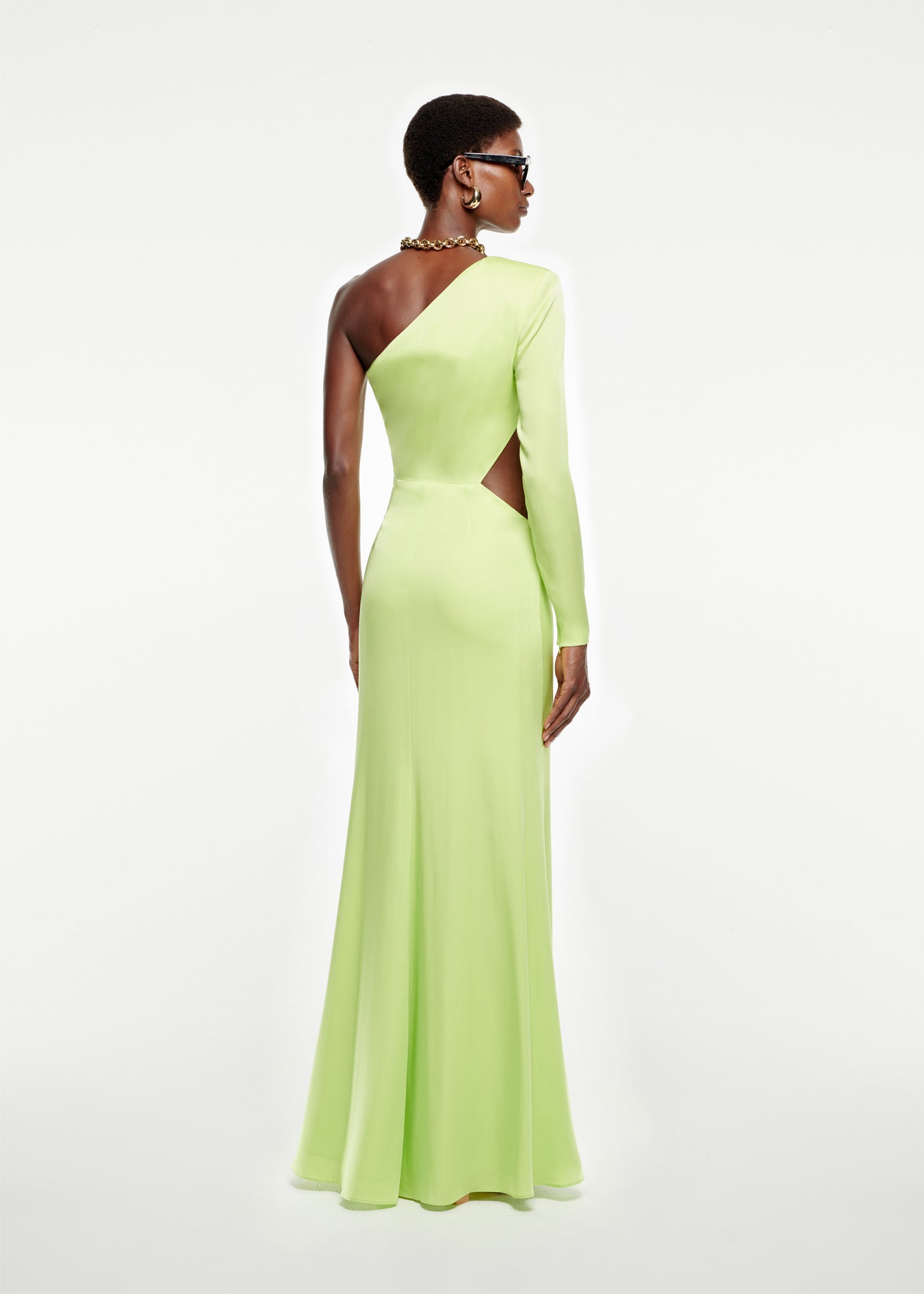 The back of a woman wearing the Asymmetric Stretch Silk Crepe Gown in Green
