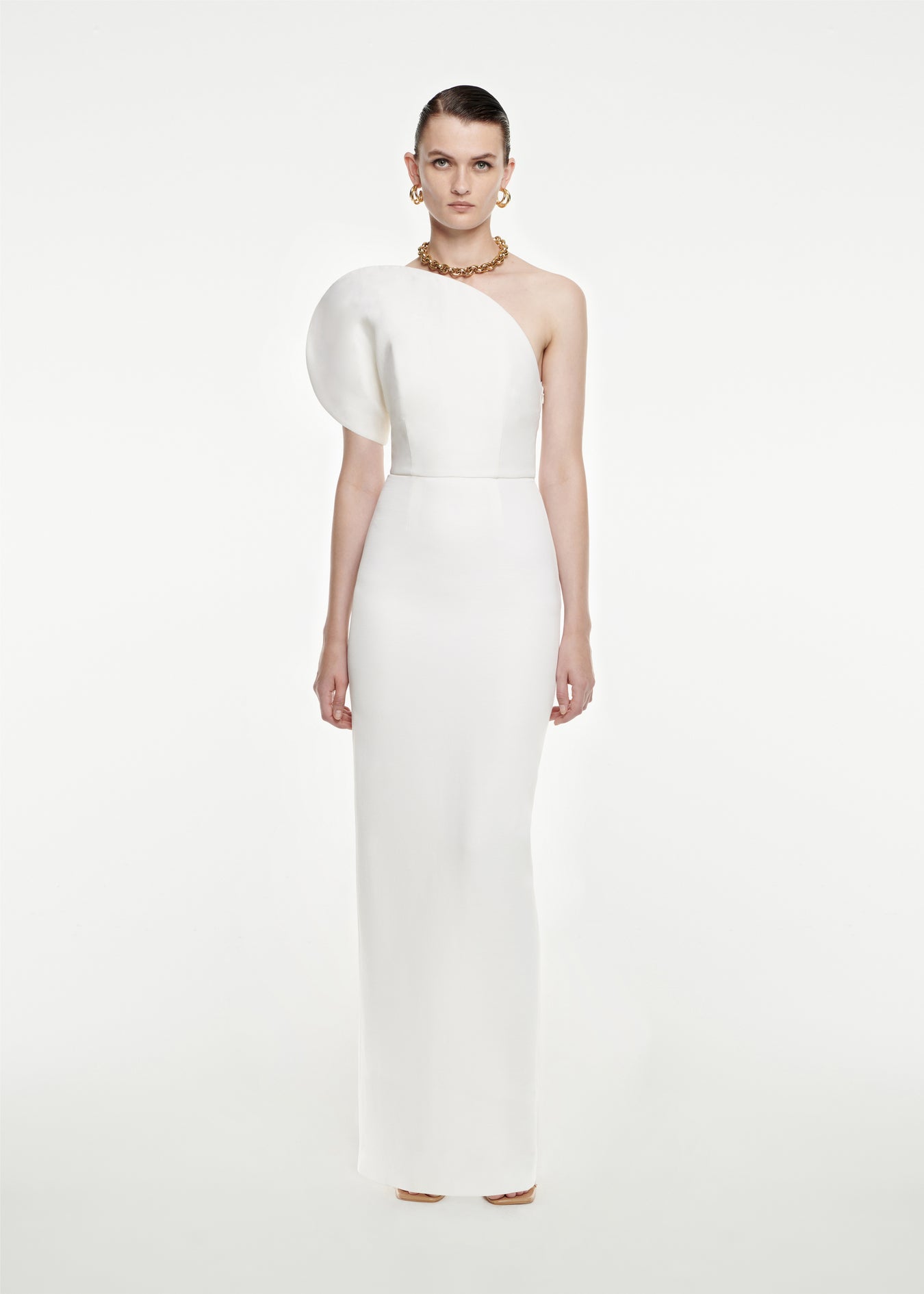 Woman wearing the Asymmetric Silk Wool Maxi Dress in White